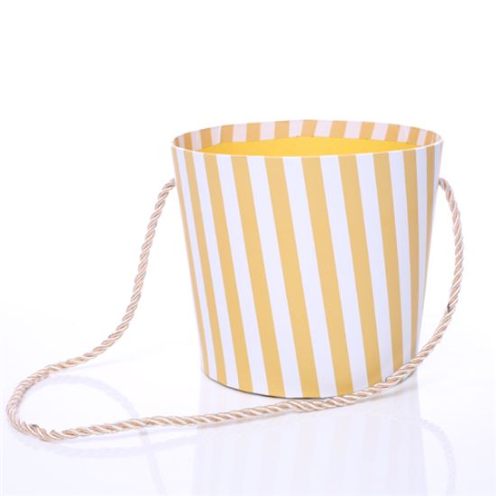 Picture of 14cm ROUND CARDBOARD FLORAL POT WITH ROPE HANDLE - STRIPED MUSTARD/WHITE